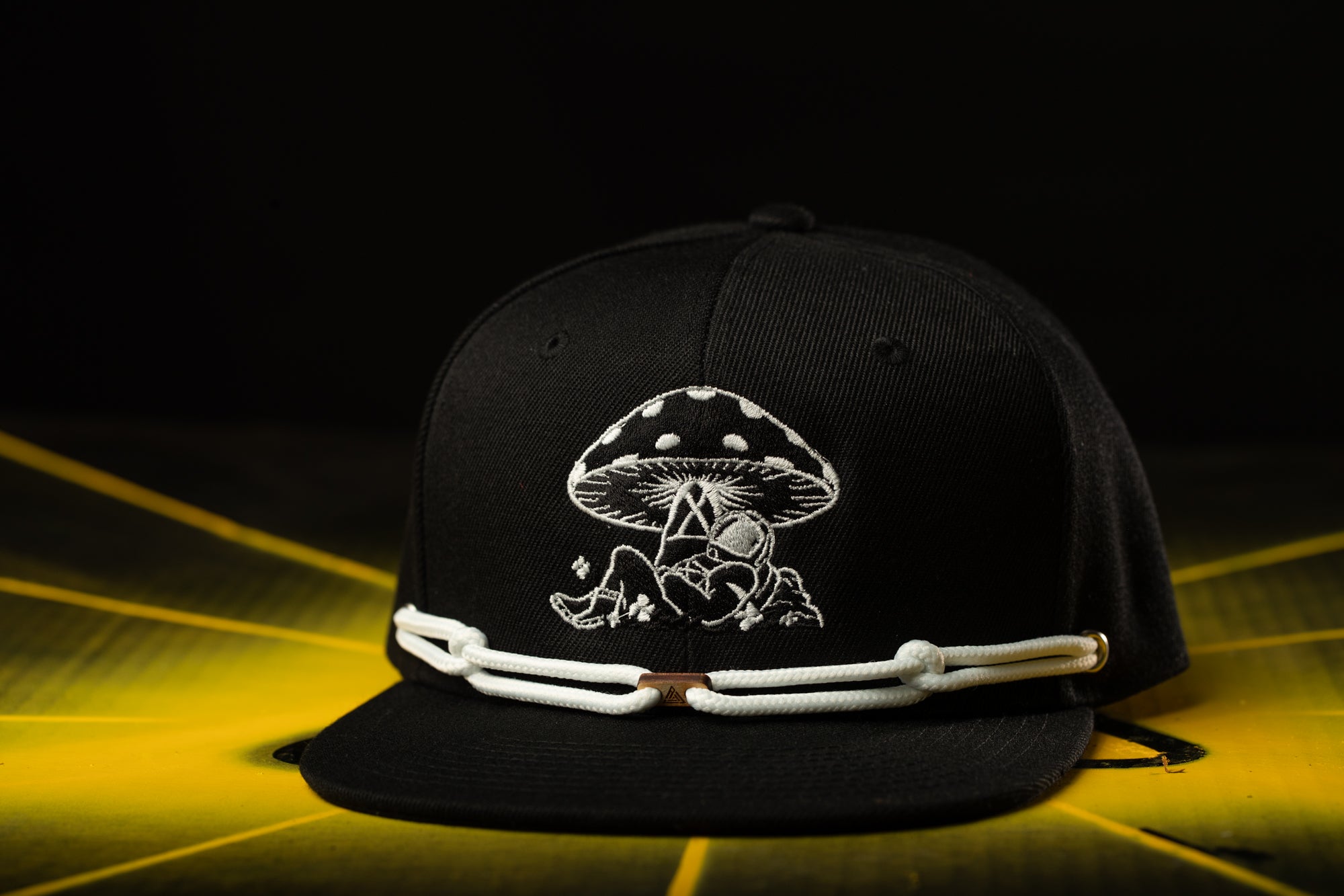 a black hat with a picture of a mushroom on it